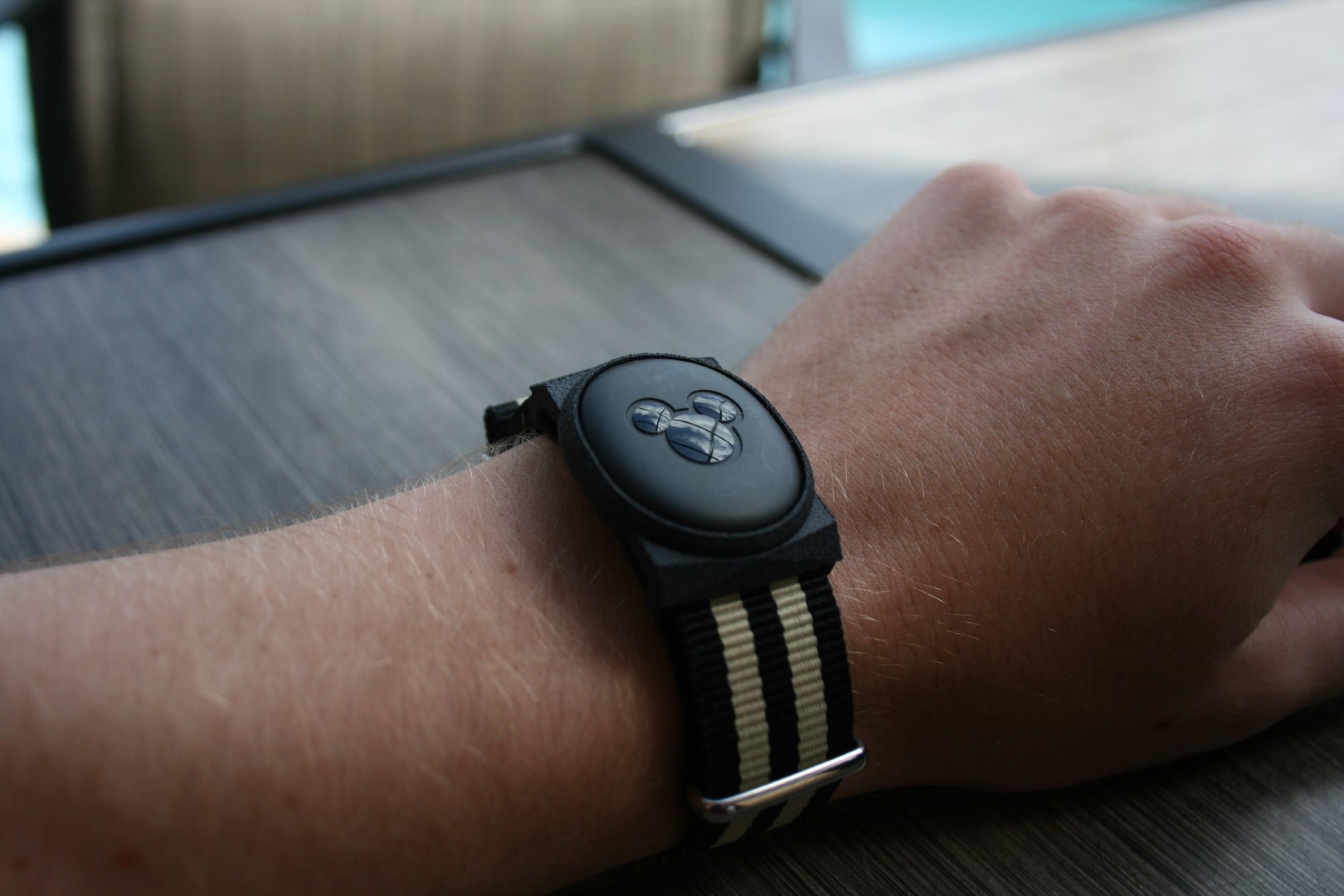 The custom magic-band sits on my arm